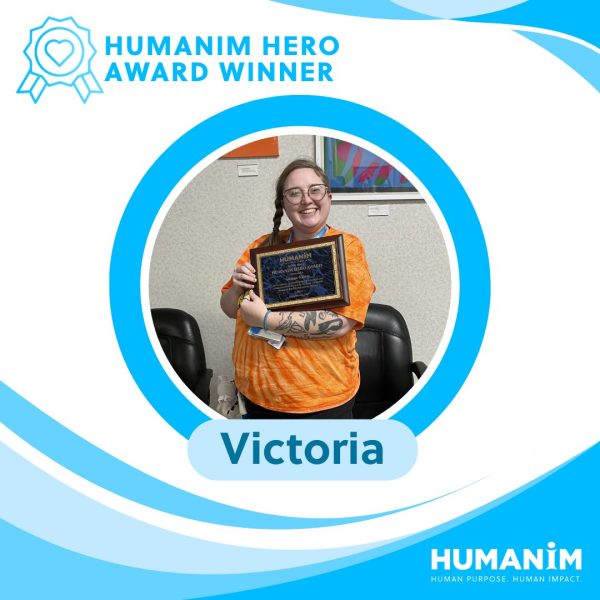 Graphic template of a picture of Victoria holding award plaque in a circle frame. Her name is underneath the picture and the words "Humanim Hero Award Winner" are on the top left next to an award ribbon icon with a heart in the middle.